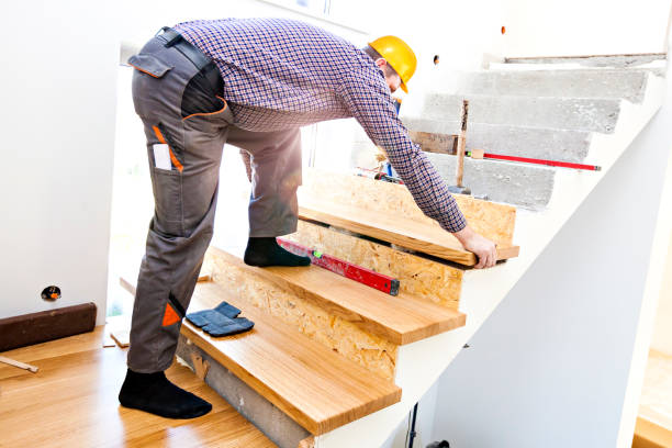 Construction worker assembles a staircase.