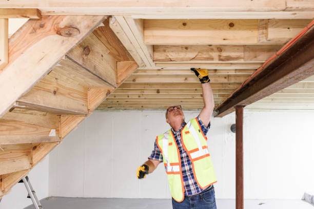 Inspection and analyzing of basement constructions. Mature gray haired agent examining basement to see if they damaged by the water.